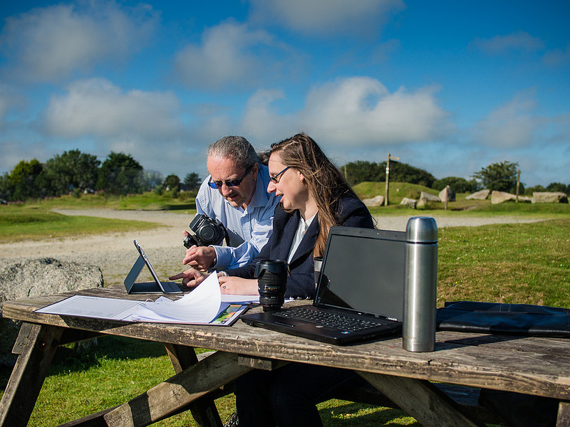 Adrian and Bergit Barnett working at a table on Bodmin Moor