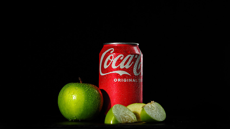 Red Coca Cola Can with cut green apples